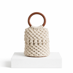White knitted bag with a wooden handle on a white background 