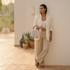 ZAWJIEN Riviera Bag - Woman in a beige suit holding a textured handbag against a light-colored wall.