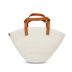 White woven handbag with brown leather handles on a white background